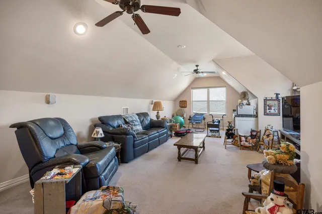 a living room with furniture a fireplace and lots of windows
