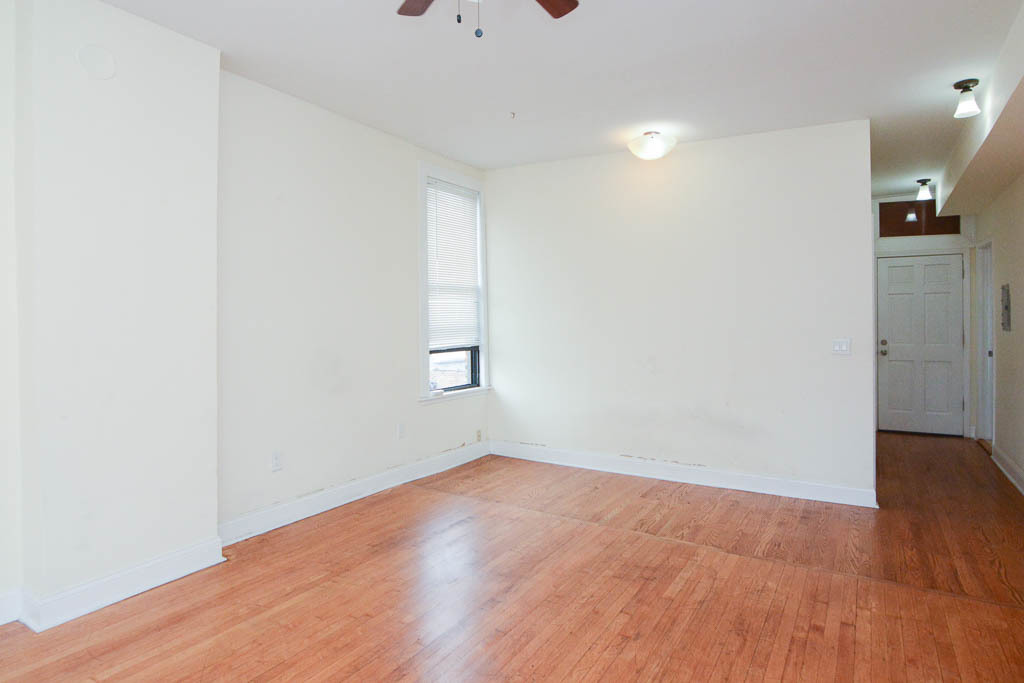2347 West 24th Place, Unit 3R Chicago, IL 60608 - Photo 11 of 20 an empty room with wooden floor and windows