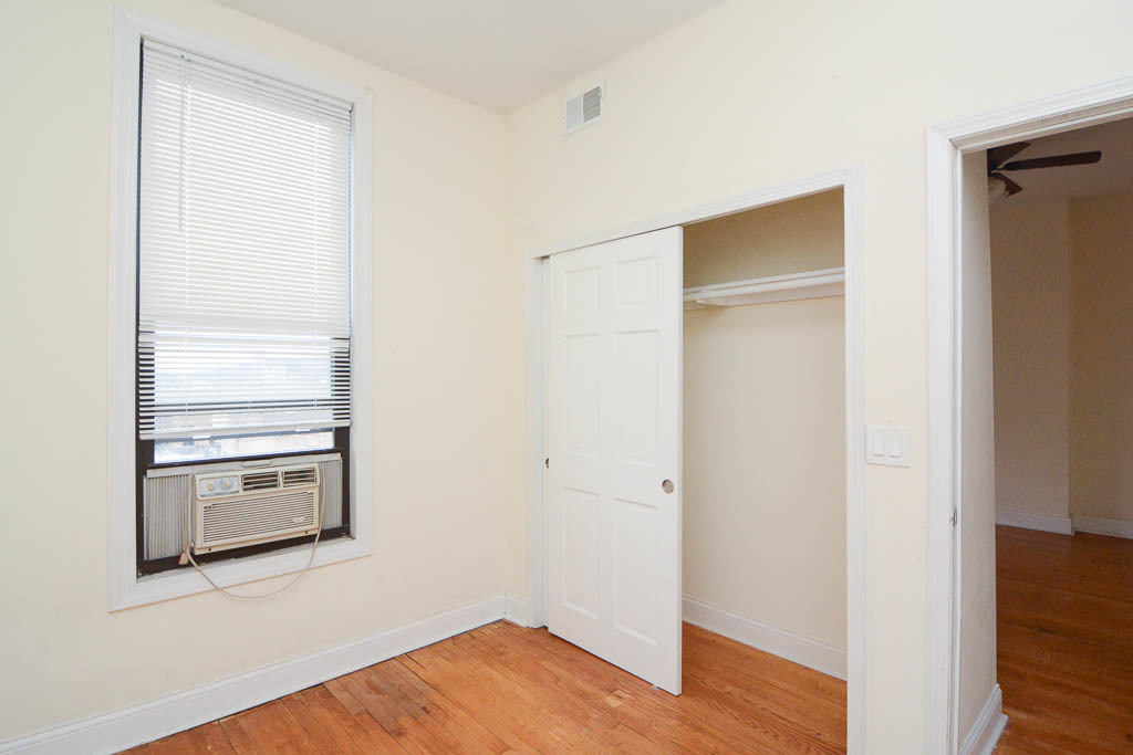 2347 West 24th Place, Unit 3R Chicago, IL 60608 - Photo 13 of 20 a room with an empty space and wooden floor