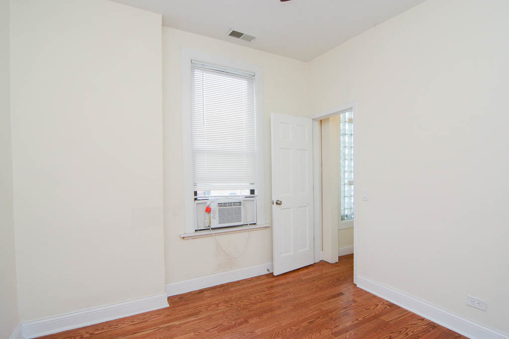 2347 West 24th Place, Unit 3R Chicago, IL 60608 - Photo 16 of 20 a view of empty room with wooden floor