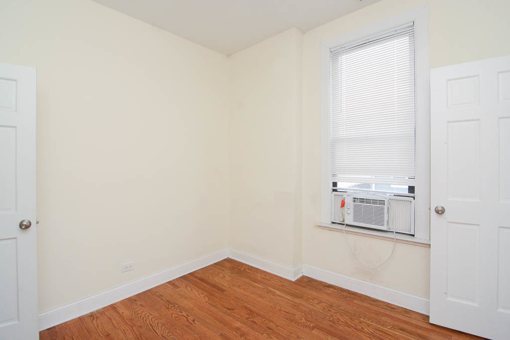 2347 West 24th Place, Unit 3R Chicago, IL 60608 - Photo 17 of 20 a view of empty room with wooden floor and cabinet