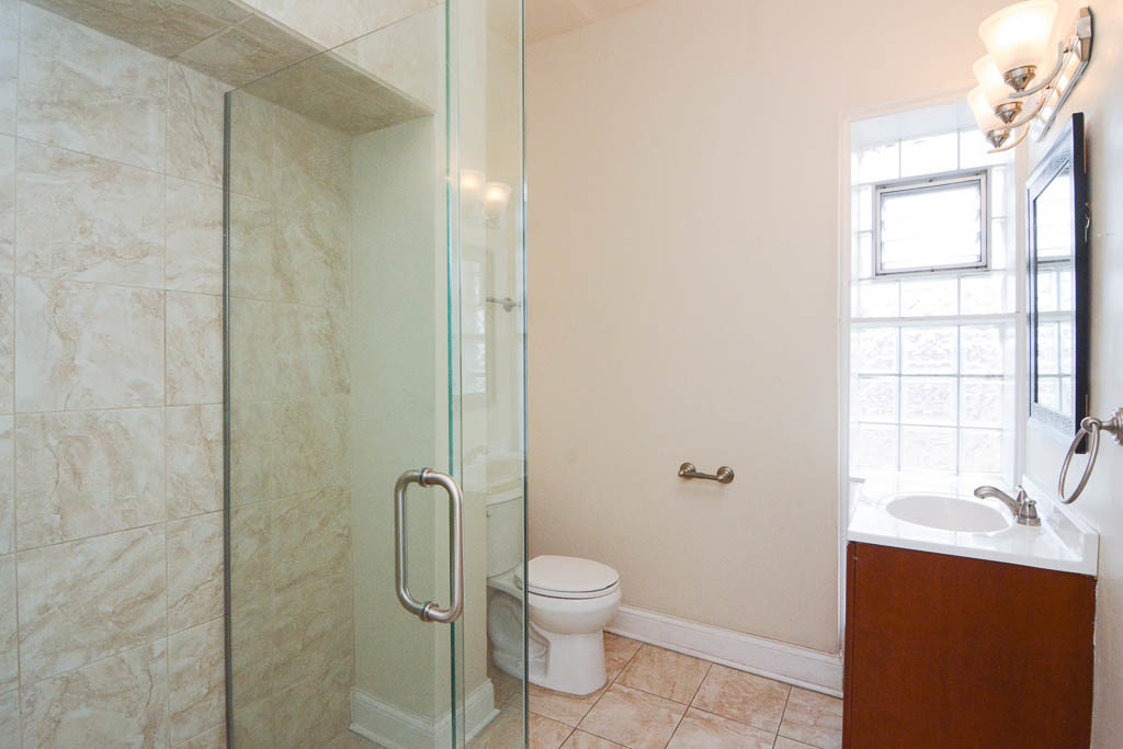 2347 West 24th Place, Unit 3R Chicago, IL 60608 - Photo 19 of 20 a bathroom with a granite countertop sink toilet and shower