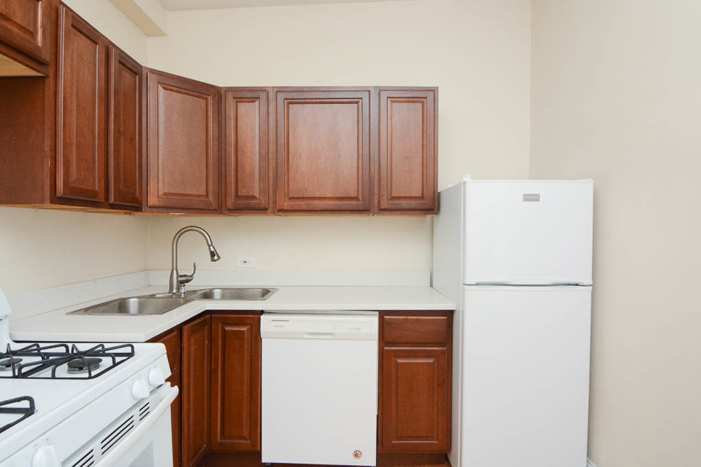 2347 West 24th Place, Unit 3R Chicago, IL 60608 - Photo 2 of 20 a kitchen with a sink a stove and a refrigerator
