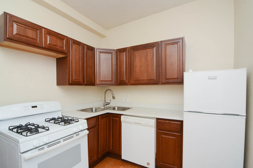 2347 West 24th Place, Unit 3R Chicago, IL 60608 - Photo 3 of 20 a kitchen with stainless steel appliances granite countertop a sink stove and refrigerator