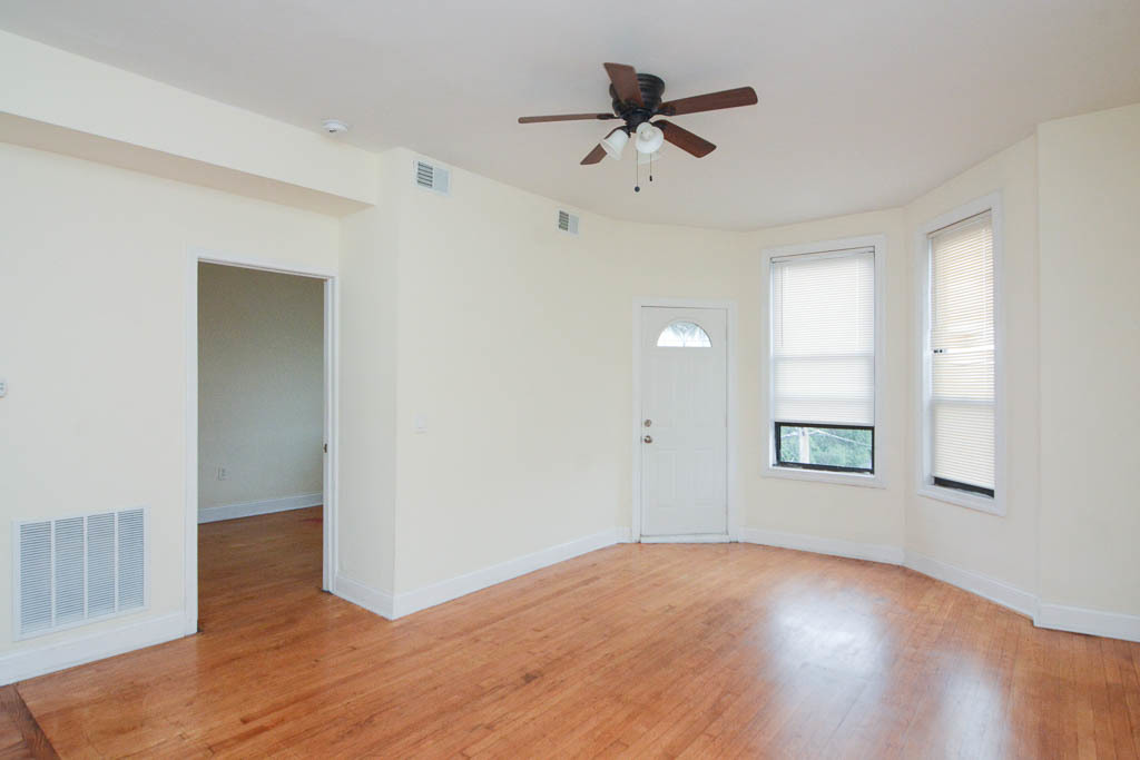 2347 West 24th Place, Unit 3R Chicago, IL 60608 - Photo 8 of 20 wooden floor in an empty room with a window