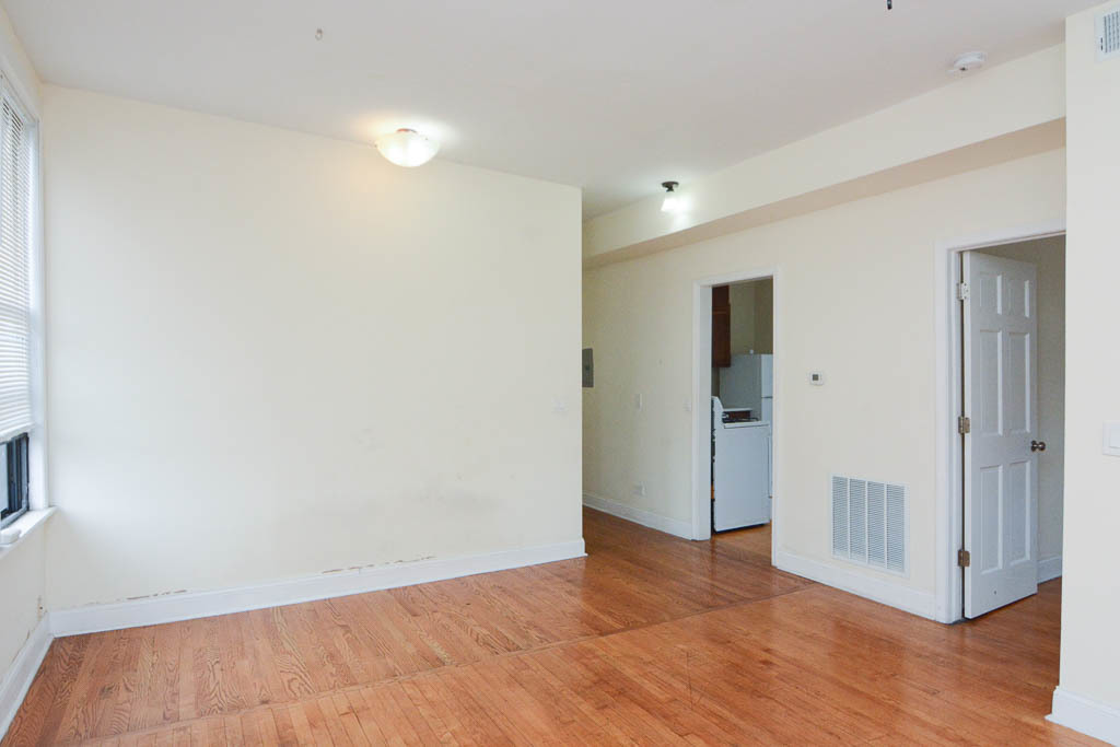 2347 West 24th Place, Unit 3R Chicago, IL 60608 - Photo 9 of 20 an empty room with wooden floor & windows and bathroom