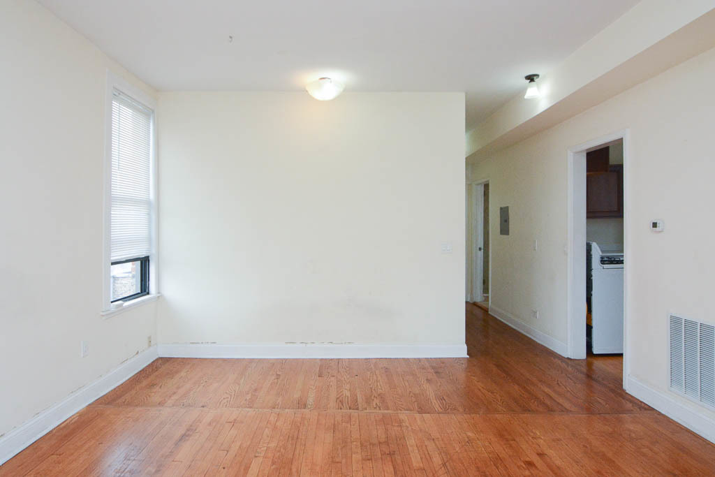2347 West 24th Place, Unit 3R Chicago, IL 60608 - Photo 10 of 20 an empty room with wooden floor and windows