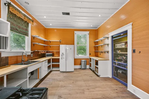 a kitchen with stainless steel appliances a stove top oven and a refrigerator