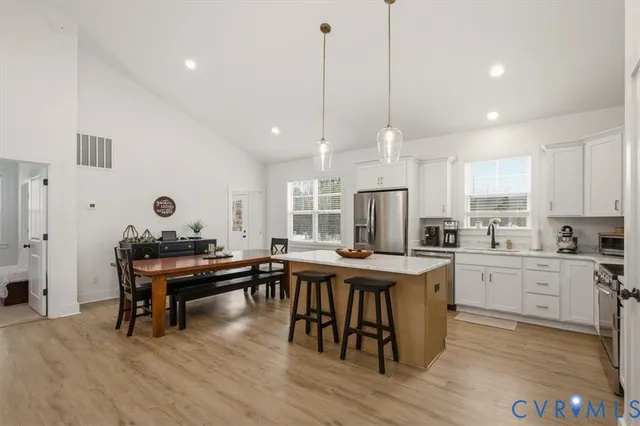 a view of a dining room with a table and chairs