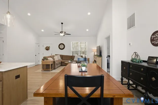 a kitchen with refrigerator a stove a sink cabinets and a window