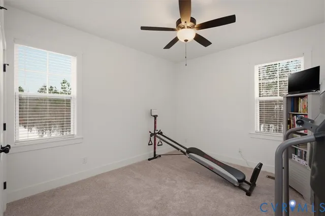 a view of a white house with a snow on the road