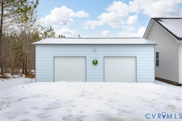 a view of large house with snow on the road