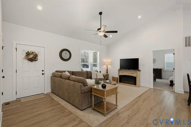 a living room with furniture a fireplace and a flat screen tv