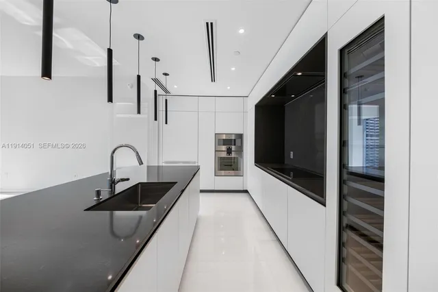 a bedroom with a large bed and a potted plant