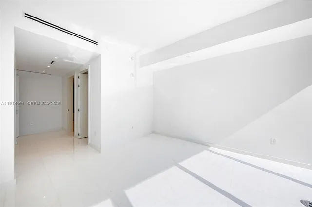 a large kitchen with stainless steel appliances kitchen island a sink dishwasher a stove and a refrigerator with wooden floor