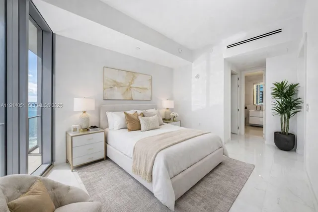 a living room with lots of furniture and a large window