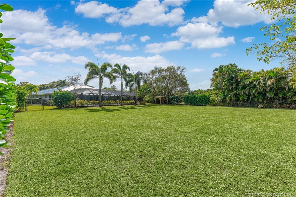 1469 Northwest Fork Road Stuart, FL 34994 - Photo 14 of 39 a view of a green field with wooden fence