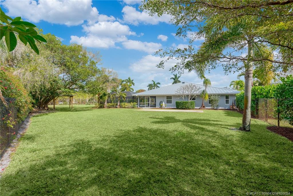 1469 Northwest Fork Road Stuart, FL 34994 - Photo 30 of 39 a view of a house with a big yard