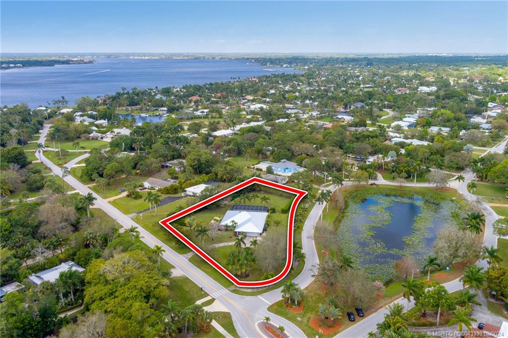 1469 Northwest Fork Road Stuart, FL 34994 - Photo 36 of 39 an aerial view of a house with a yard and lake view