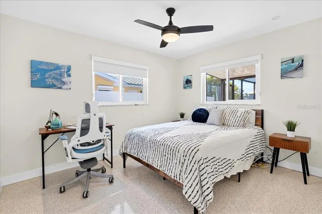 a bedroom with a bed a desk and chair