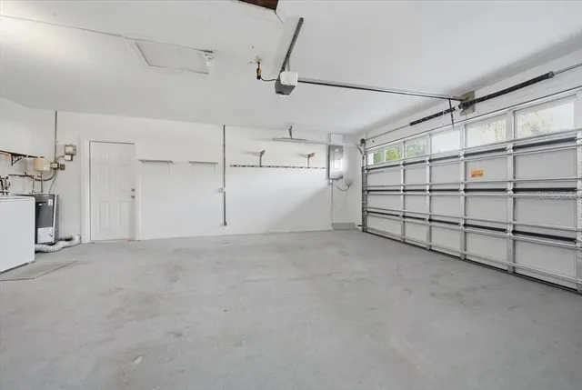 an aerial view of a house with a swimming pool yard and lake view