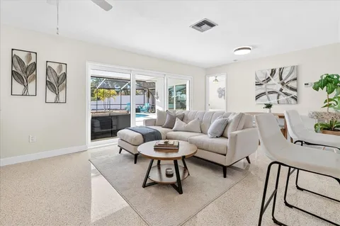 a living room with furniture and a potted plant