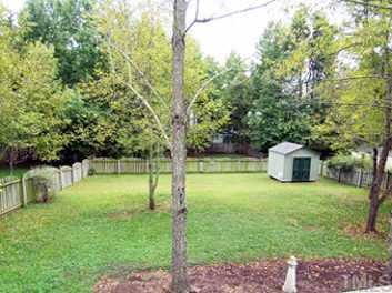 9317 Dawnshire Road Raleigh, NC 27615 - Photo 8 of 9 As seen from the Deck, the gorgeous fenced backyard offers lots of trees & shade, as well as an attached Storage Rm & a Storage Shed.