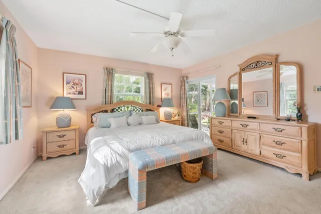 a spacious bedroom with a large bed and a dresser