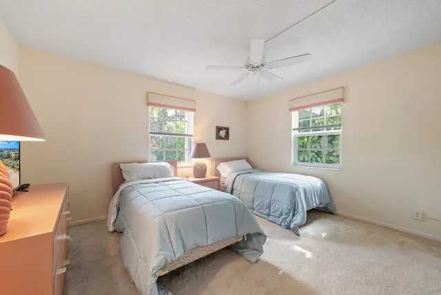 a bedroom with two beds and a window