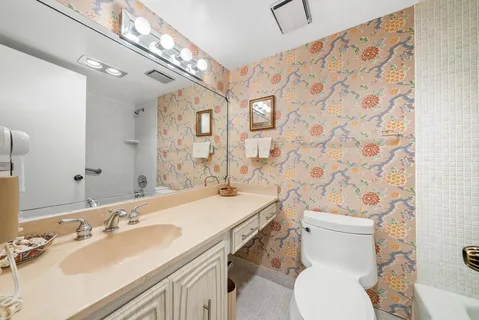 a bathroom with a sink a toilet and shower curtain