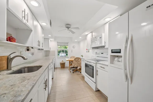 a kitchen with sink cabinets and stove