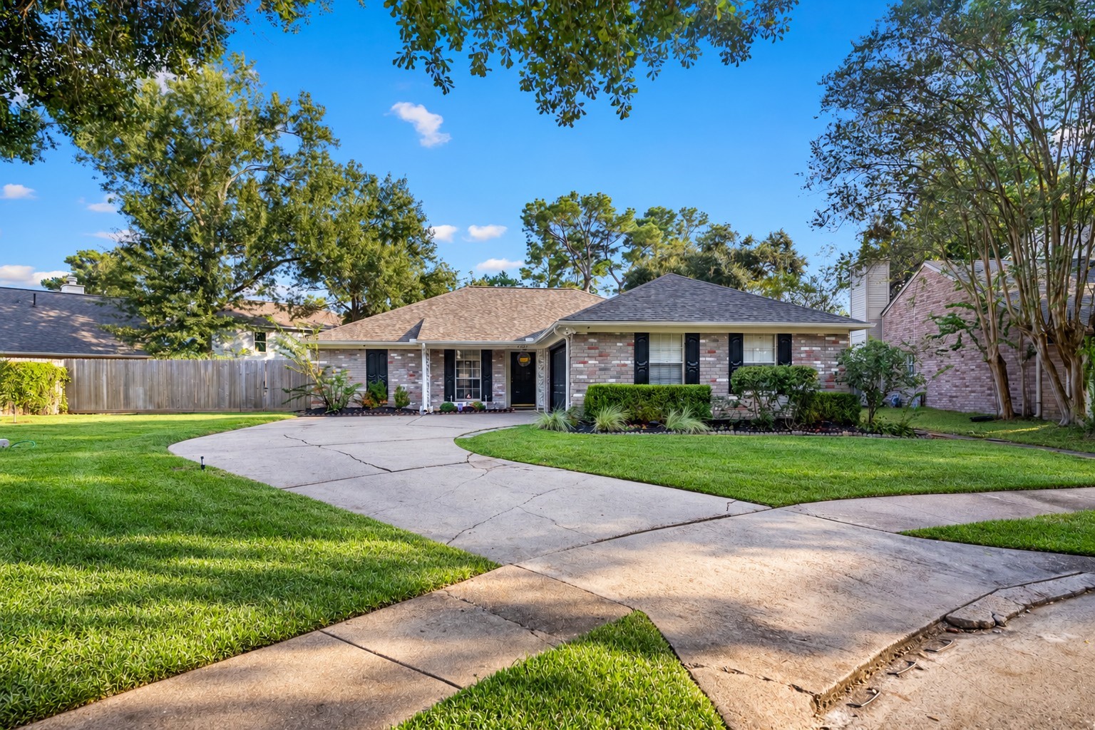 9107 Towerstone Court Spring, TX 77379 - Photo 1 of 42 Charming single-story brick home with a spacious front yard, mature trees, and a curved driveway, offering inviting curb appeal.