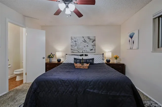 a bedroom with a bed and lamp