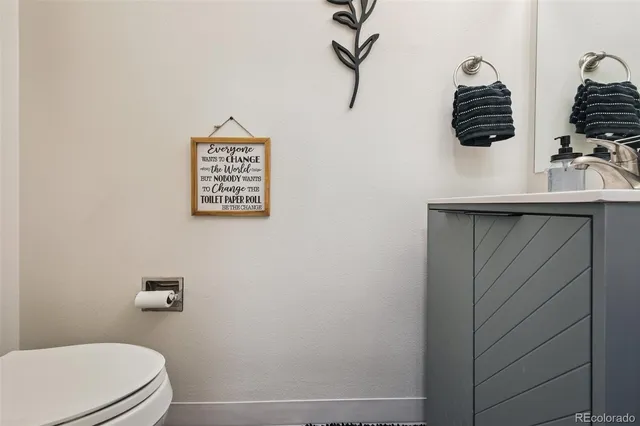 a bathroom with a toilet a sink and vanity