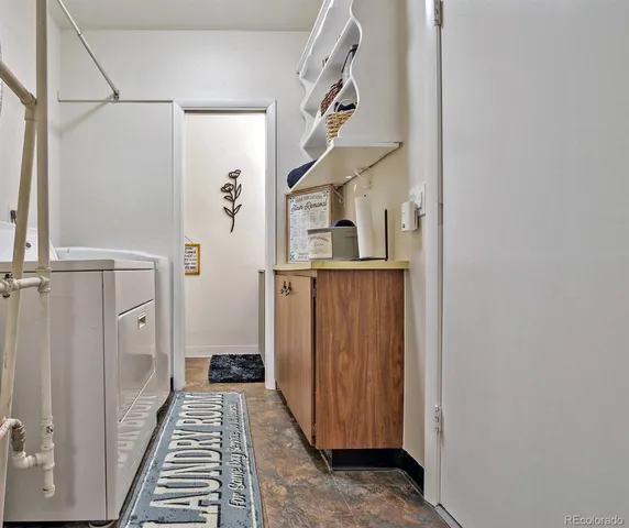 a view of a hallway with wooden floor and entryway