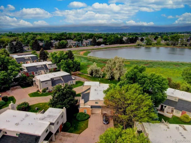 an aerial view of a house with outdoor space and lake view in back