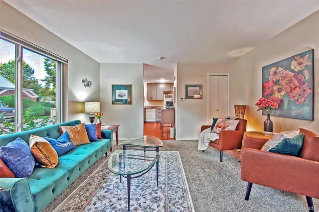 a living room with furniture a rug and a large window