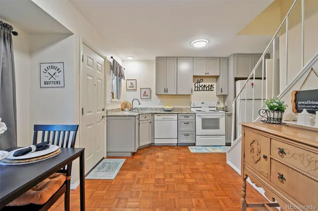a kitchen with stainless steel appliances a stove a sink and a refrigerator