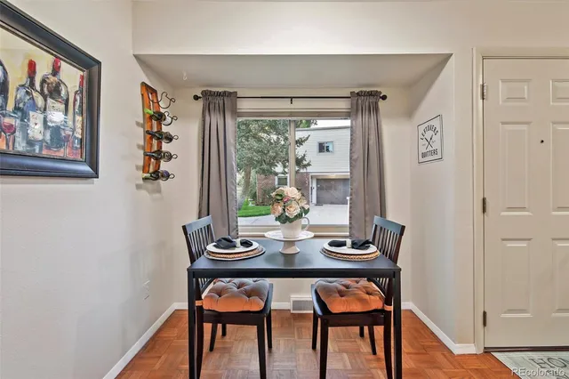 a view of a dining room with furniture and wooden floor