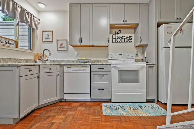 a kitchen with cabinets appliances and a sink