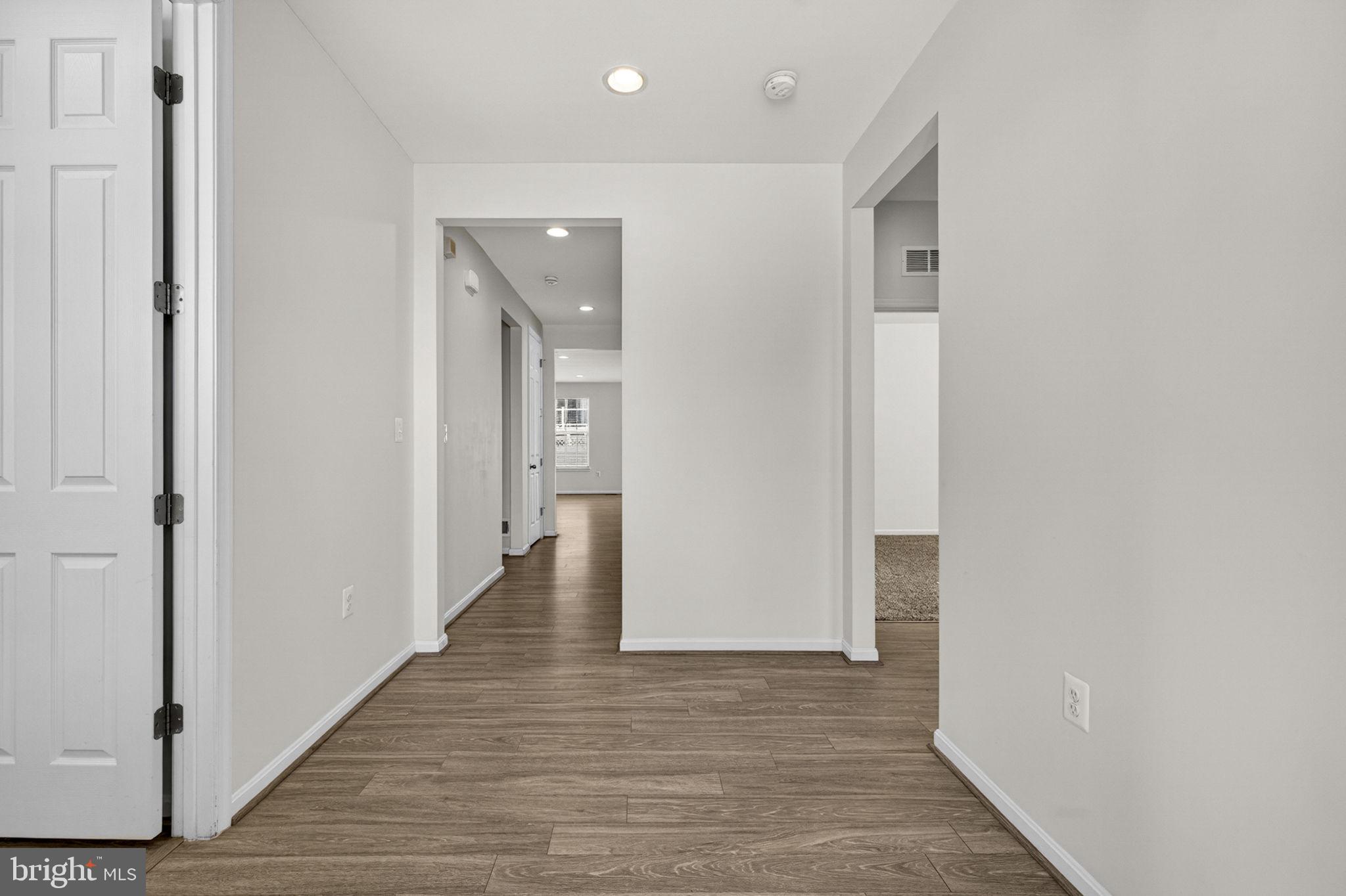 181 Sparkling Brook Road Ranson, WV 25438 - Photo 19 of 101 a view of a hallway with wooden floor