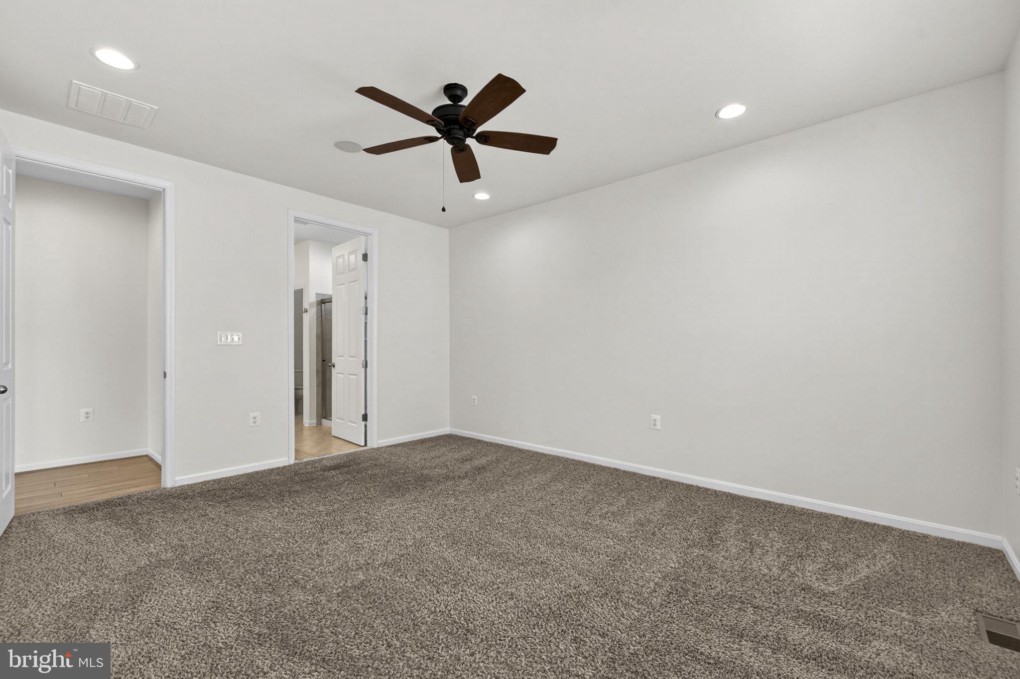 181 Sparkling Brook Road Ranson, WV 25438 - Photo 51 of 101 a view of a big room with a ceiling fan