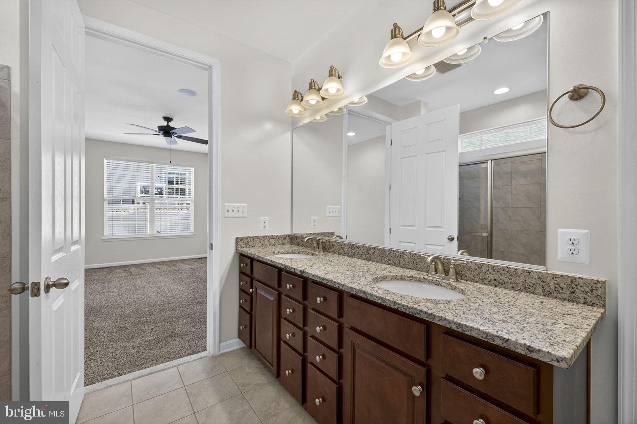 181 Sparkling Brook Road Ranson, WV 25438 - Photo 55 of 101 a bathroom with a granite countertop double vanity sink and a mirror