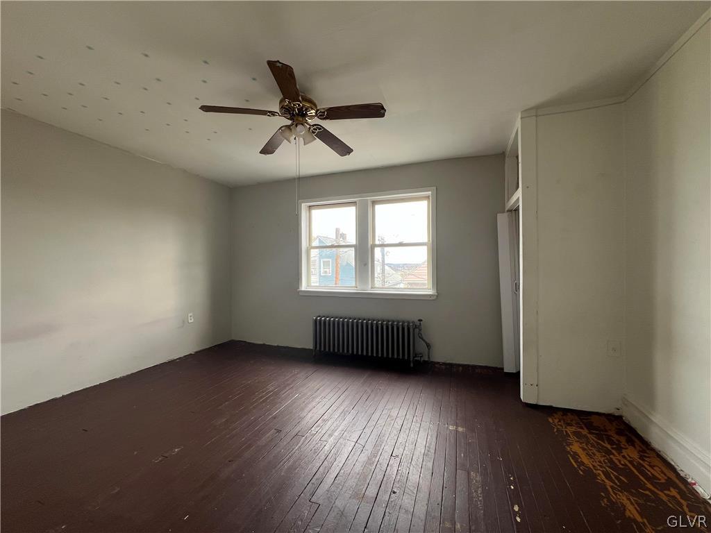 644 William Street Bethlehem, PA 18015 - Photo 12 of 15 an empty room with wooden floor a ceiling fan and windows