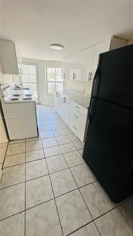 a kitchen with a black white checkered floor