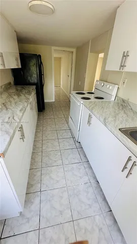 a view of a kitchen with a sink and a stove top oven
