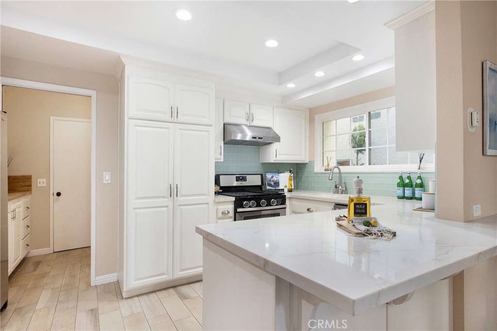 326 17th Street Seal Beach, CA 90740 - Photo 5 of 26 a kitchen with a sink a stove and refrigerator