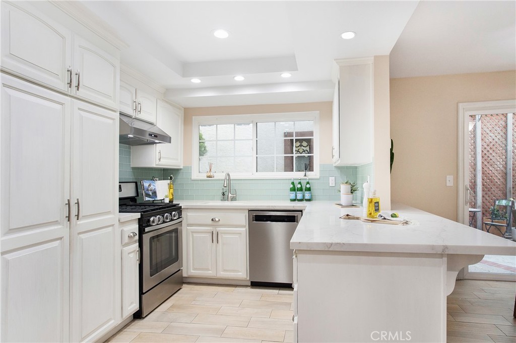 326 17th Street Seal Beach, CA 90740 - Photo 6 of 26 a kitchen with a sink stove and refrigerator