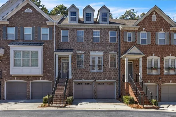 a view of a brick house with a yard