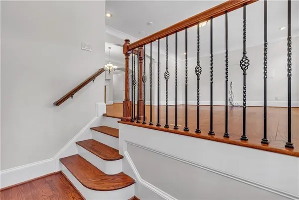 a view of a hallway with wooden floor and a window